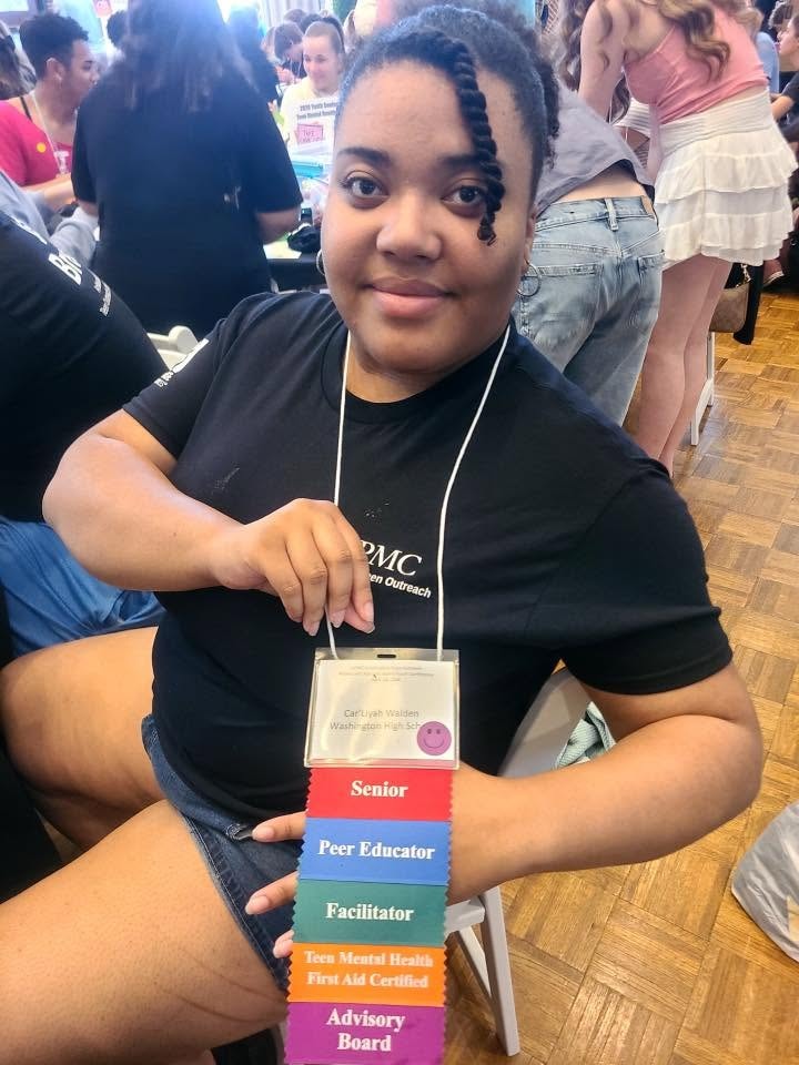 SW PA Teen Outreach teen with role badges at conference