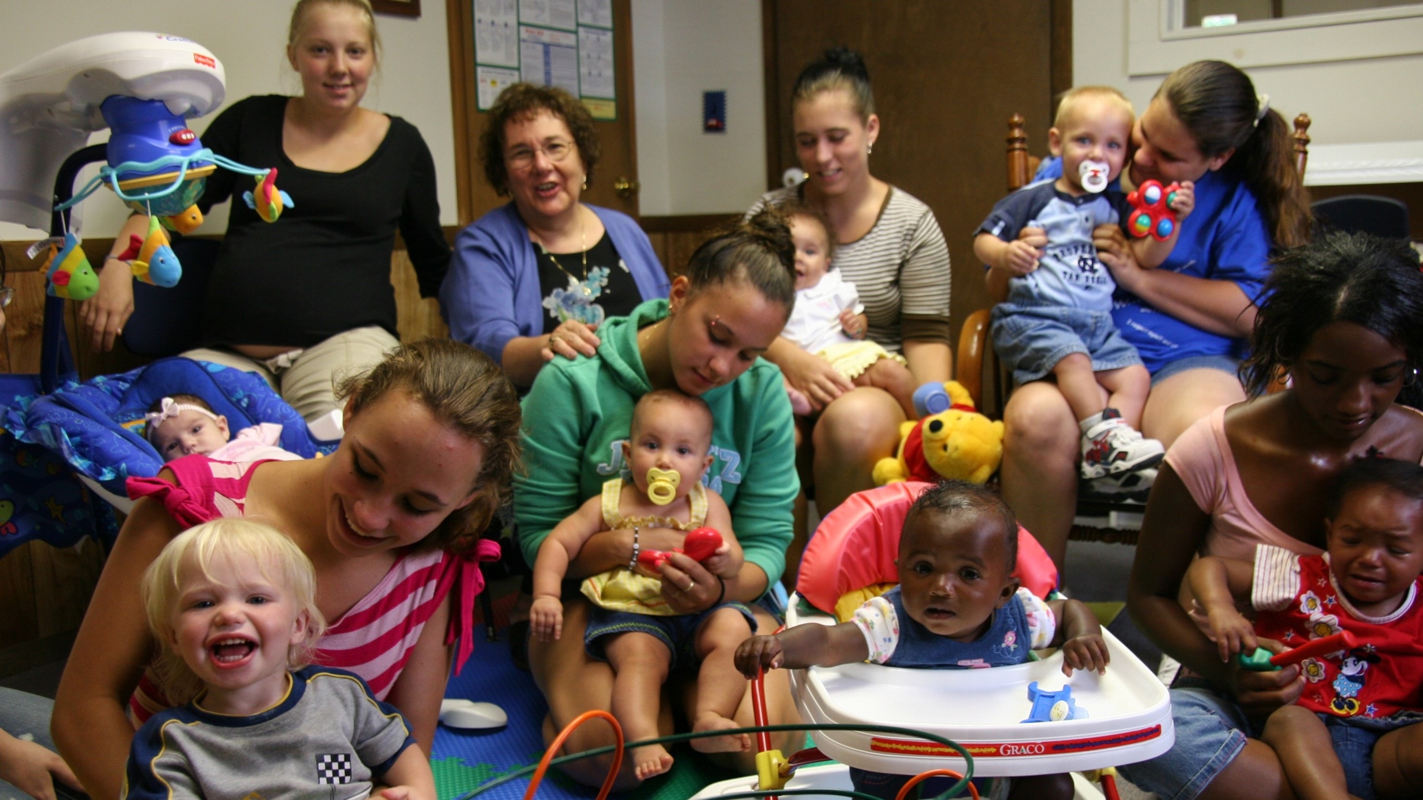 Young mother holding her child outdoors — ELECT program