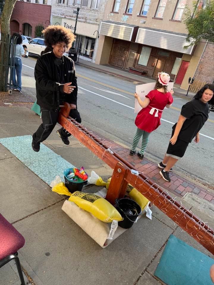 Peer Education teens on a seesaw outdoors
