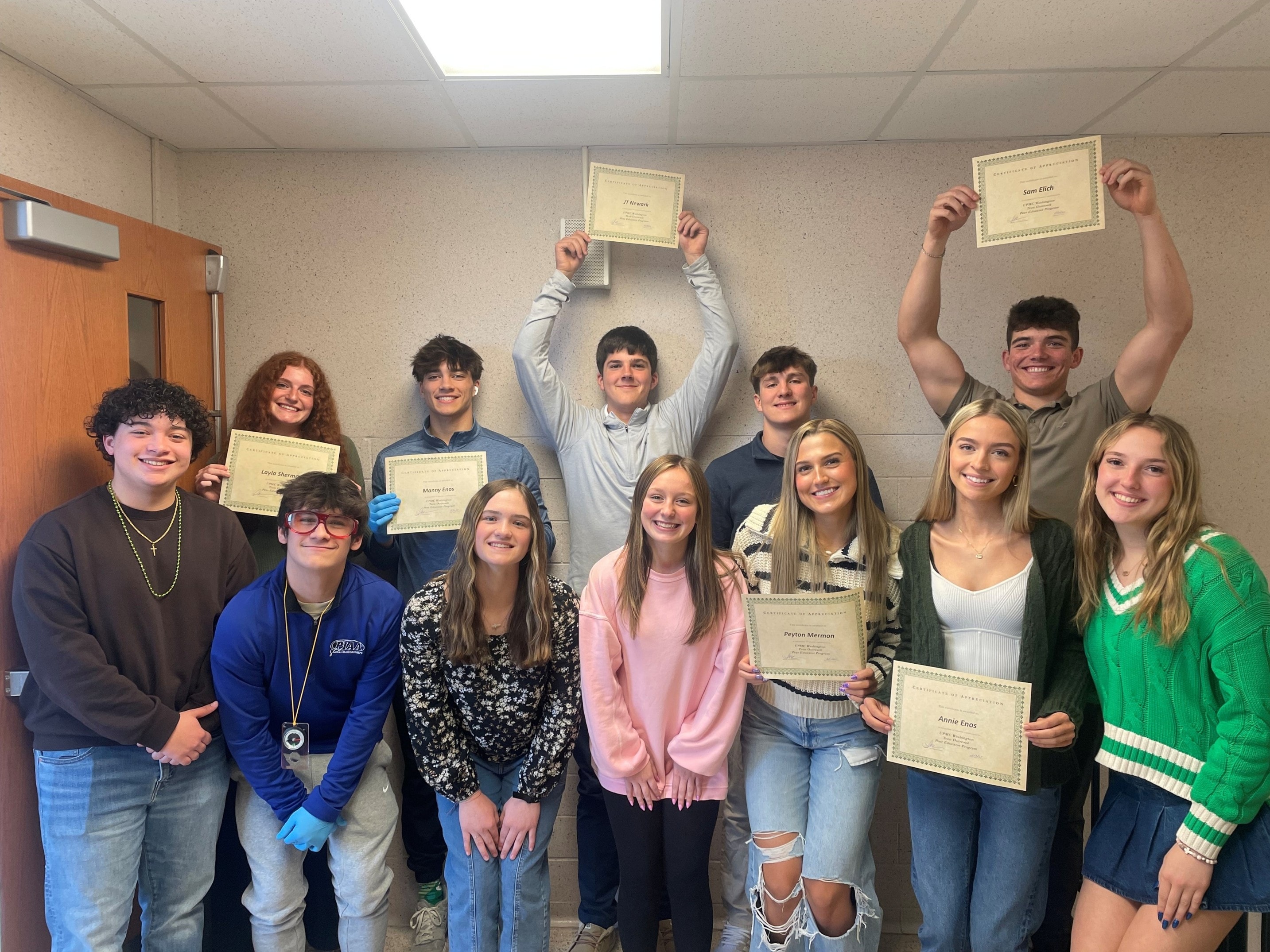 Respect Online peer educators holding certificates of appreciation